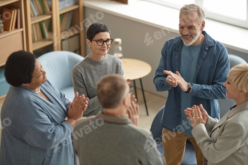 Preview: Group of Senior People Applauding in Support Meeting