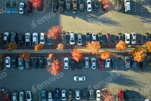 Preview: Aerial view of large parking lot with many parked colorful cars.