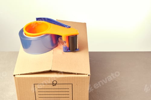 Preview: brown packing box with sealing machine on top