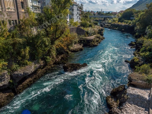 Preview: River crossing the city of Mostar with the bridge in the background