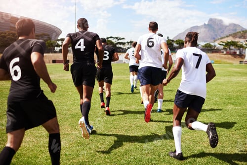 Preview: Shot of a group of young rugby players running onto the field during a game