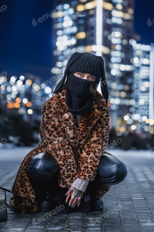 Preview: A woman in a leopard print fur coat and a balaclava with ears on a street in the Christmas holidays