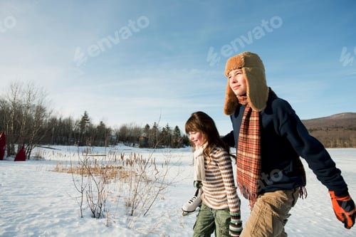 Preview: Brother and sister walking in snow