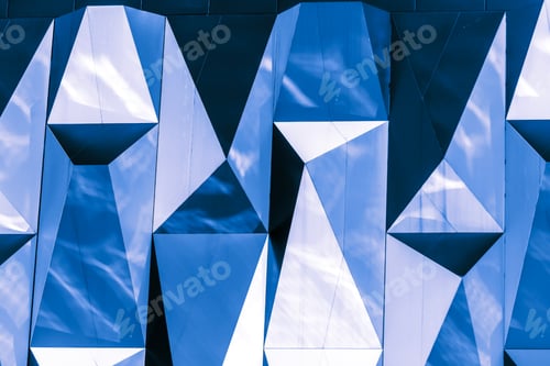 Preview: A wall of a building with a geometric pattern composed of multifaceted mirror-like blue panels