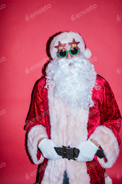 Preview: Man dressed as Santa Claus gesturing with funny glasses