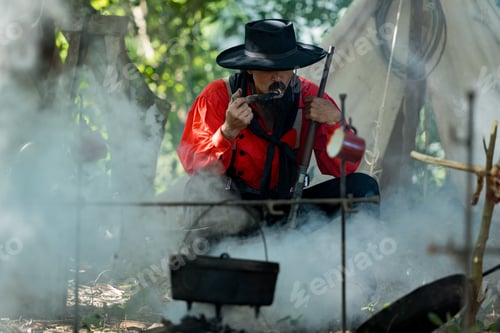 Preview: A cowboys preparing food at a campfire, roasting meat together in a warm