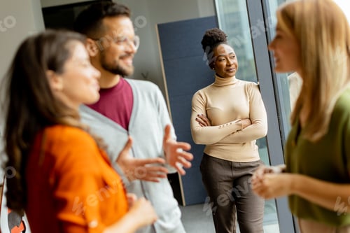 Preview: Cute Africam American woman with her young multiethnic startup team working in the modern office