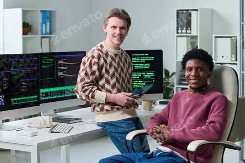 Preview: Young Man and Young Black Man Collaborating in Office