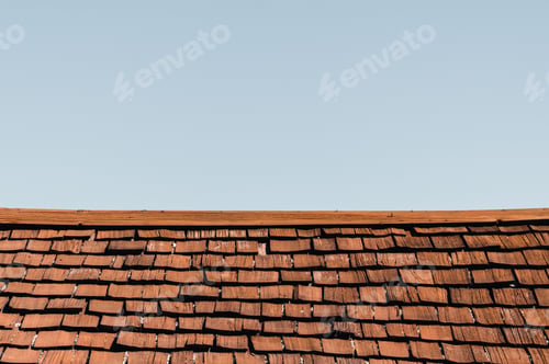 Preview: Old wooden rustic roof with a blue sky in the background