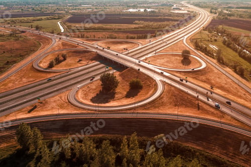 Preview: Aerial shot of freeway loop with many vehicles driving in various directions, drone pov