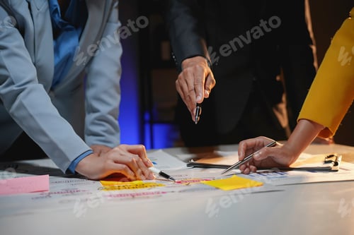 Preview: Business people are having a brainstorming session, using colorful sticky notes to plan a project