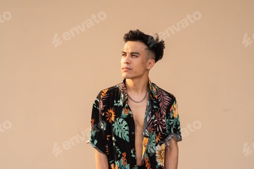 Preview: Portrait of handsome young cool man against plain background