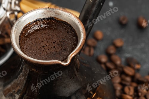 Preview: Coffee beans and turk on dark surface