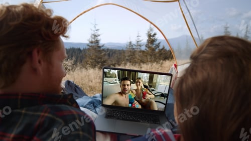 Preview: Distant friends communicating web camera on trip. Smiling couple talking screen