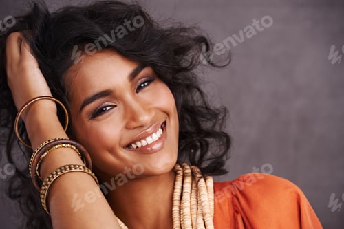 Preview: Homegrown beauty. Studio portrait of a beautiful young woman posing against a gray background.