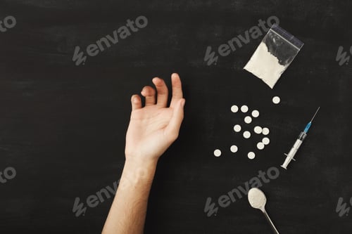 Preview: Drug addict hand on dark table