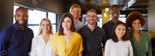 Preview: Portrait Of Smiling Multi-Cultural Business Team In Modern Open Plan Office Together