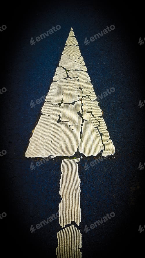 Preview: Vertical top view of an o road sign on the asphalt showing the direction