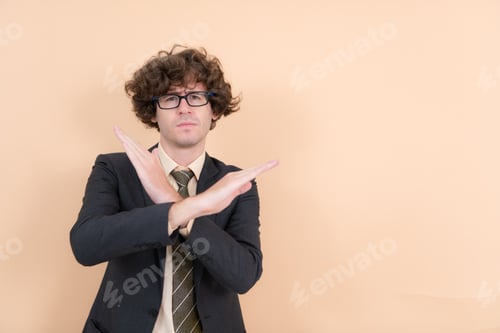 Preview: Portrait of a handsome young man with curly hair on a beige background