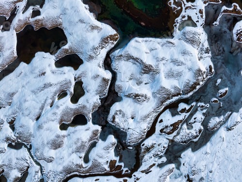 Preview: Abstract natural landscape of snowy ground and winding river on remote wilderness in winter