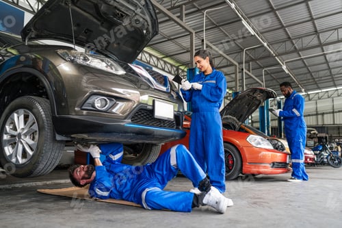 Preview: Team Auto mechanic in blue uniform are repair and maintenance auto engine.