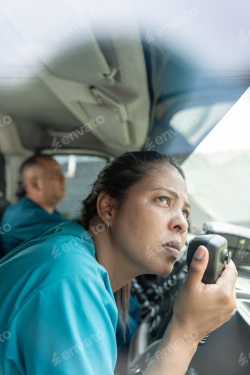 Preview: Worried woman looking out the window of the ambulance and uses the radio