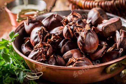 Preview: Homemade baked chestnuts on a copper pan