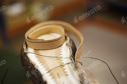 Preview: Close up of thread and shoe leather in shoe makers workshop