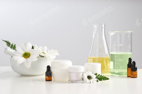 Preview: Skin care products, ingredients and laboratory glassware on table. Dermatology research