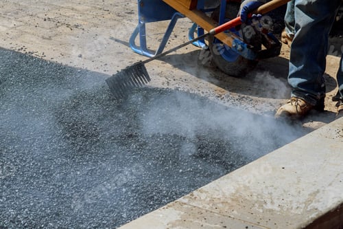 Preview: Urban road is under construction, asphalting in progress, fragment of yellow roller