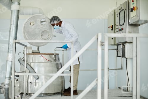 Preview: Male Technician Looking inside of Tank while Inspecting Production Process at Pharmaceutical Factory