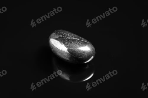 Preview: Beautiful shiny hematite gemstone on black background