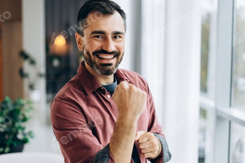 Preview: Man celebrating victory achieving success with clenched fist