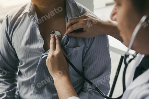 Preview: Asian doctor is using a stethoscope listen to the heartbeat of the elderly patient.