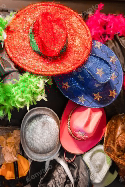 Preview: Colorful and glittery party hats hanging in the shop for party supplies.