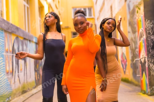 Preview: Urban style fashion with three black African girls on a city street
