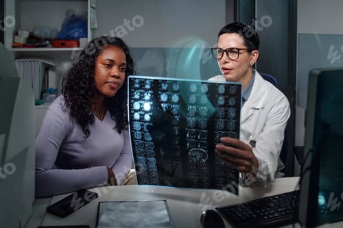 Preview: Doctor Reviewing MRI Scan with Patient in Medical Office