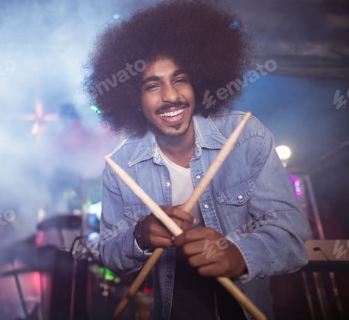 Preview: Smiling Man Holding Drumsticks on Stage