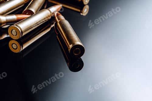 Preview: Rifle bullets or cartridges on black shiny background