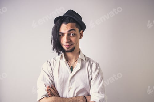 Preview: Young Adult in Hat with Crossed Arms Smiling