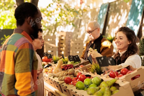 Preview: Multiracial couple buying fresh organic produce at farmers market