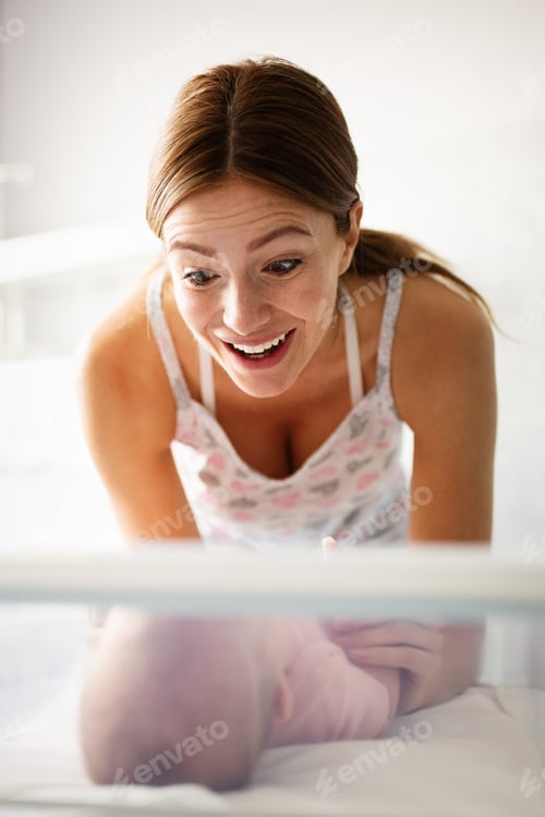 Preview: Mother holding her newborn baby child after labor in a hospital