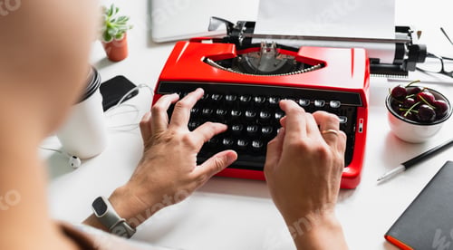Preview: Woman hand working with bright red vintage typewriter