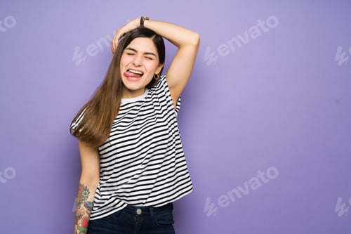 Preview: Portrait of a latin young woman making a funny face