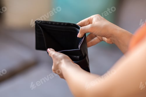 Preview: Closeup Shot Of Unrecognizable Female Holding Empty Wallet At Home