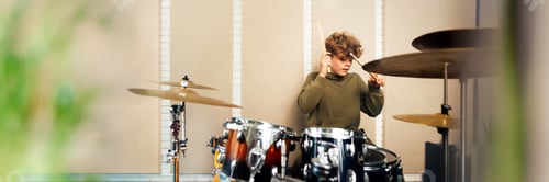Preview: Young Drummer Playing in a Studio Wide Banner