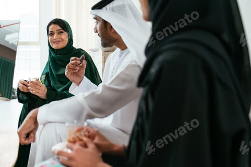 Preview: Emirati friends enjoying tea and conversation in living room