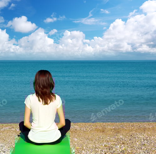 Preview: Woman Meditating on Beach with Calm Ocean View
