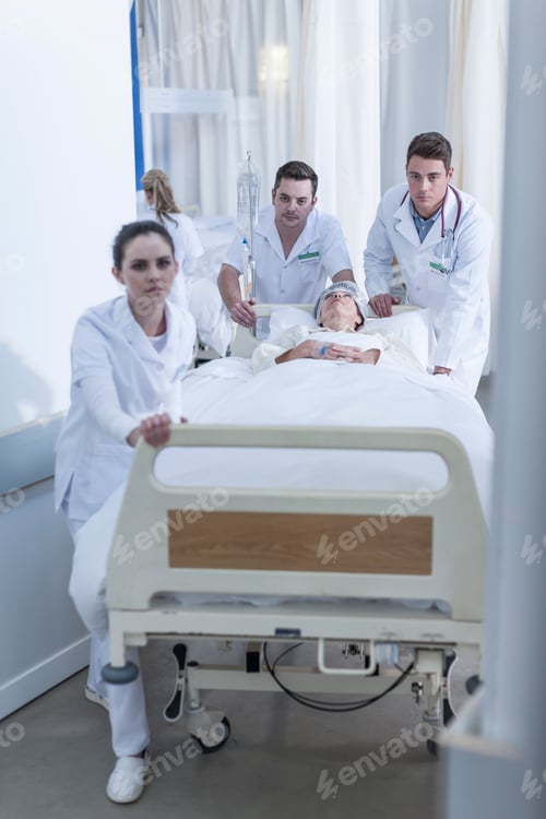 Preview: Hospital staff pushing bed with patient on floor