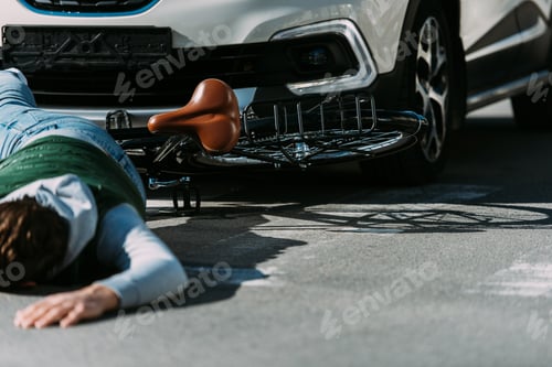 Preview: partial view of male bicycle rider hit by car on road, car accident concept